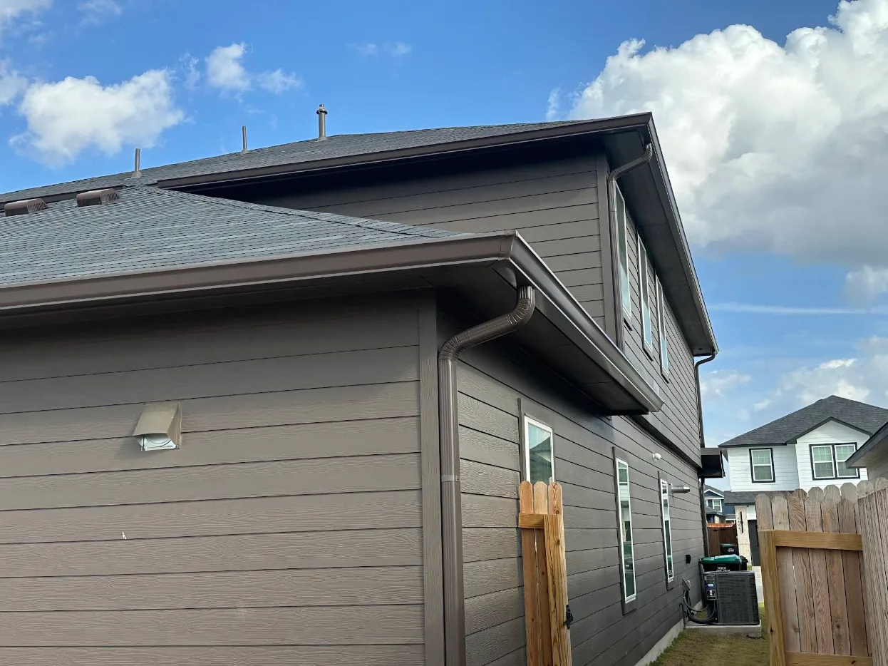 Finished seamless gutter and downspout on a completed San Antonio installation